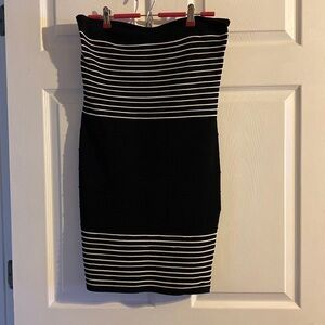 Demanding strapless form fitting black dress with white stripes